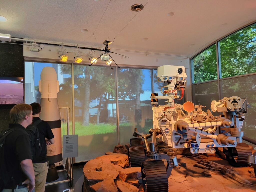 Alec Forsman looking at JPL's model of the Perserverance Mars Rover